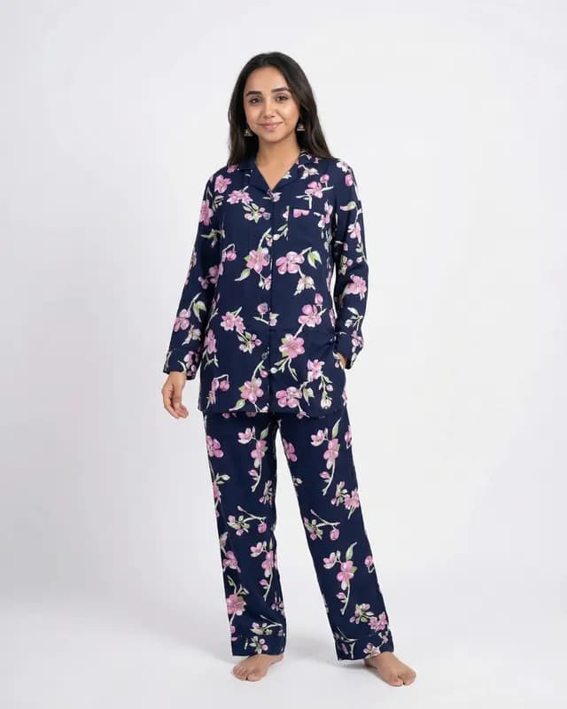 Woman wearing a navy blue and pink floral full sleeve linen PJ set